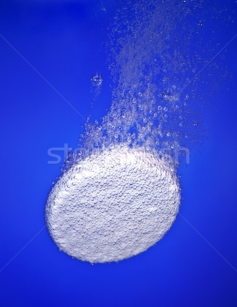 Effervescent tablet in water with bubbles Stock photo © cookelma