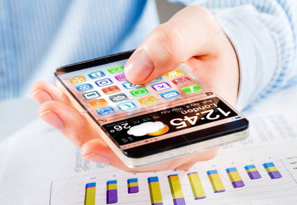 Stock photo: Smartphone with transparent screen in human hands.