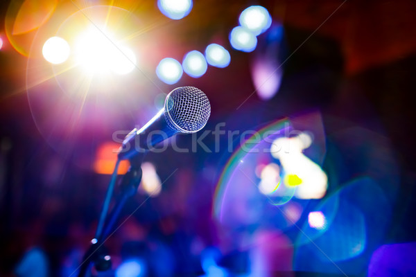 Stock photo: Microphone on stage against a background of auditorium.