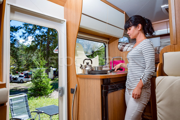 Woman cooking in camper, motorhome RV interior Stock photo © cookelma