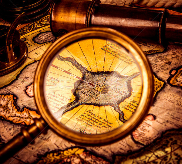 Vintage magnifying glass lies on the ancient map of the North Po Stock photo © cookelma