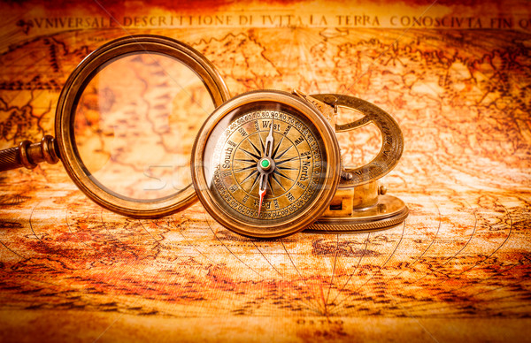 Vintage magnifying glass lies on an ancient world map Stock photo © cookelma