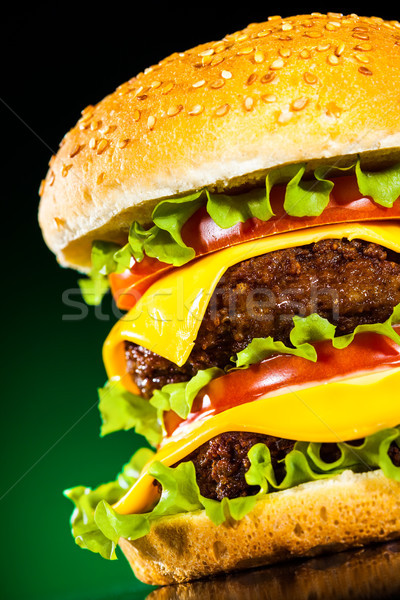 Tasty and appetizing hamburger on a darkly green Stock photo © cookelma
