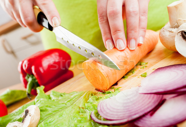 Stock photo: Woman's hands cutting vegetables