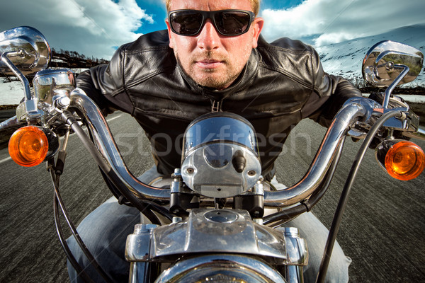 Funny Biker in sunglasses and leather jacket racing on mountain  Stock photo © cookelma