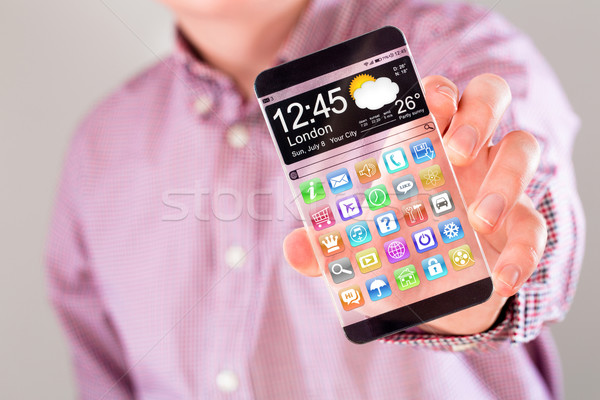 Smartphone with transparent screen in human hands. Stock photo © cookelma