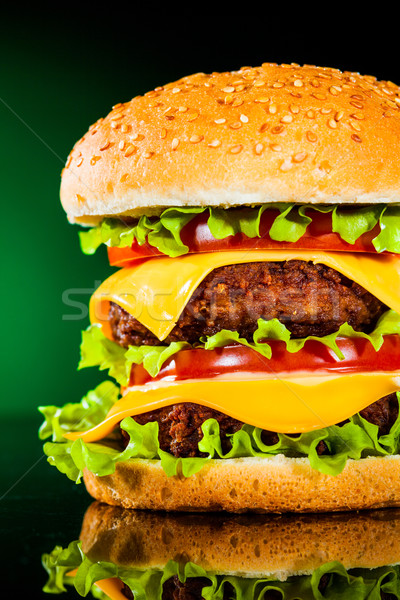 Tasty and appetizing hamburger on a darkly green Stock photo © cookelma