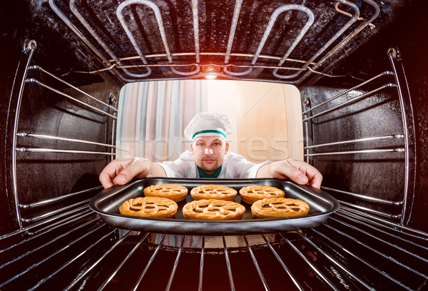 Chef cooking in the oven. Stock photo © cookelma