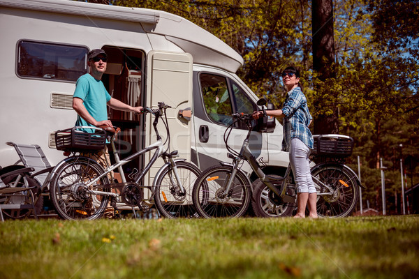 Woman with a man on electric bike resting at the campsite. Stock photo © cookelma