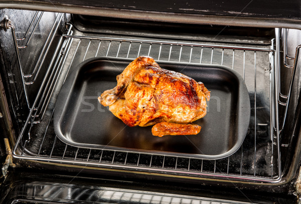Roast chicken in the oven. Stock photo © cookelma