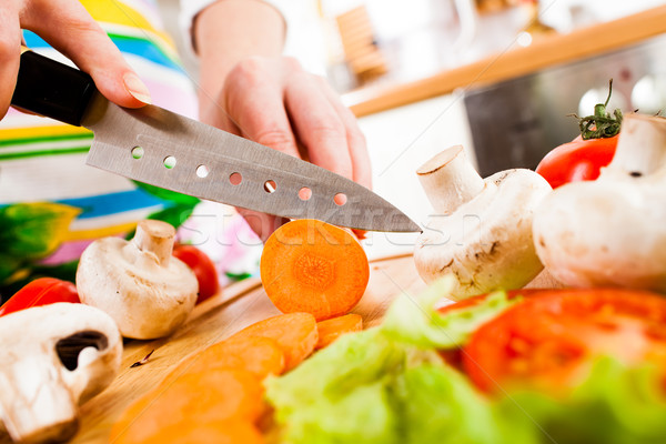 Stock photo: Woman's hands cutting vegetables