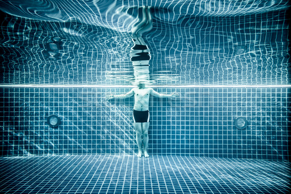 Persons standing under water in a swimming pool Stock photo © cookelma