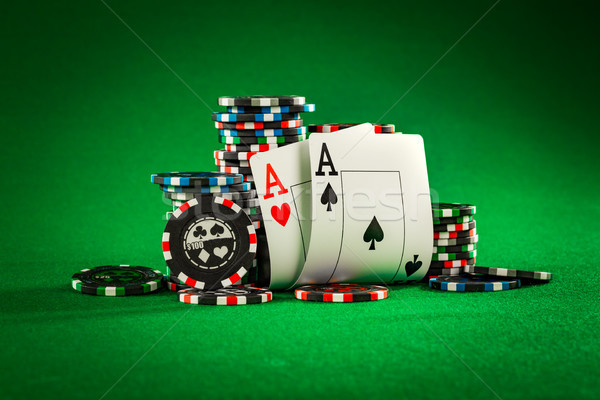 Stack of chips and two aces on the table on the green baize Stock photo © cookelma