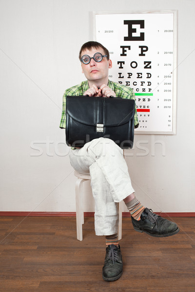 Stock photo: person wearing spectacles in an office at the doctor