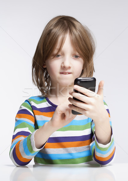 Fiú olvas szöveges üzenet mobiltelefon szőke haj Stock fotó © courtyardpix