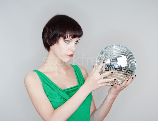 Disco ball młoda kobieta patrząc odizolowany szary Zdjęcia stock © courtyardpix