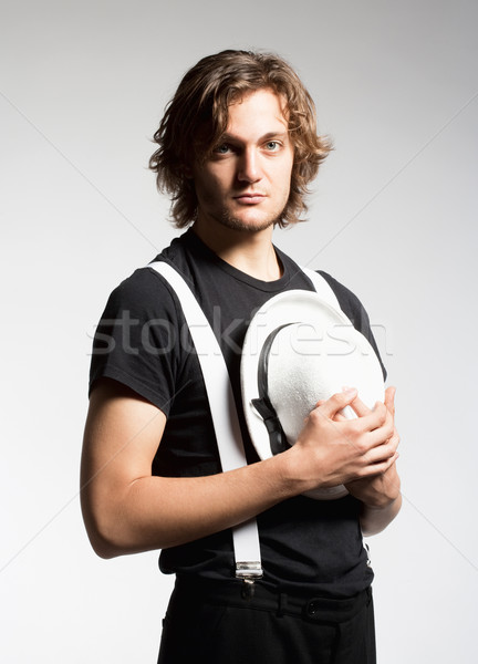 Junger Mann braune Haare halten weiß hat Porträt Stock foto © courtyardpix