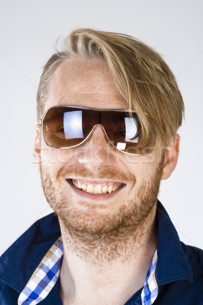 портрет молодым человеком Солнцезащитные очки изолированный серый лице Сток-фото © courtyardpix