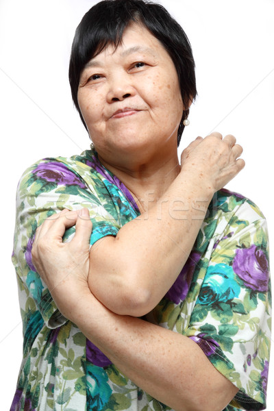 Senior woman doing a series of warm-up exercises Stock photo © cozyta