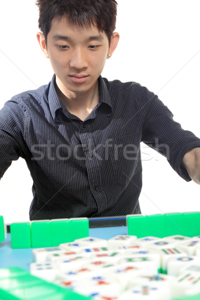 Stock photo: Chinese man play Mahjong, traditional China gamble. 