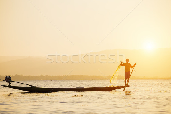 Fisherman of Lake in action when fishing Stock photo © cozyta