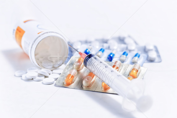 Syringe with glass vials and medications pills  Stock photo © cozyta