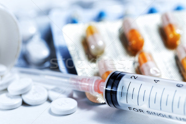 Stock photo: Syringe with glass vials and medications pills drug