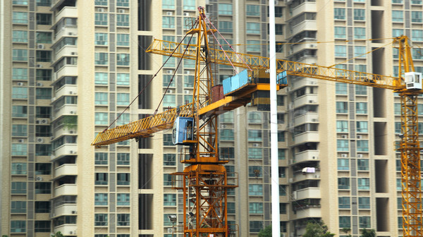 Building of a skyscraper with two tower cranes  Stock photo © cozyta