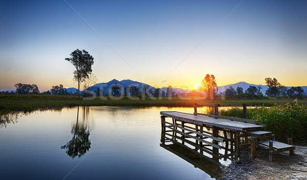 Serene Sunrise over fishing Jetty Stock photo © cozyta