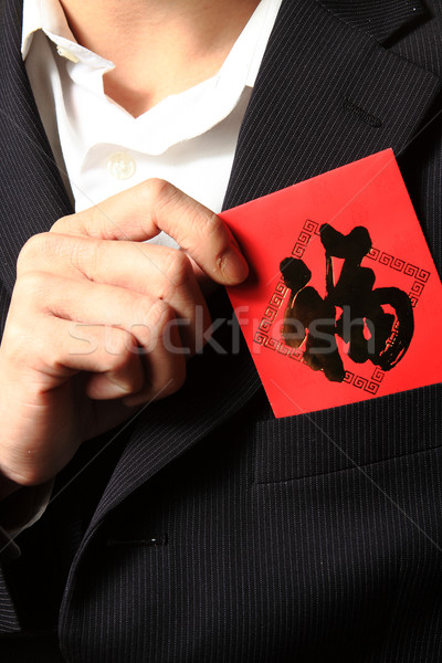 businessman putting chinese cash gift in his pocket Stock photo © cozyta