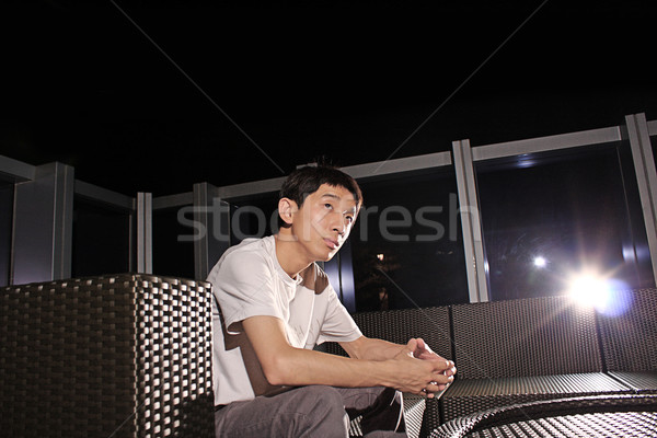 Man sit on a bench while relaxing at a pub.  Stock photo © cozyta