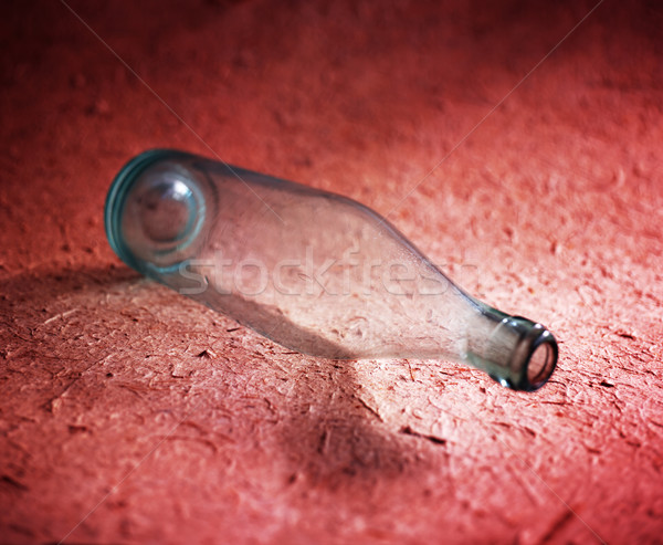 Empty bottle on red Stock photo © crisp
