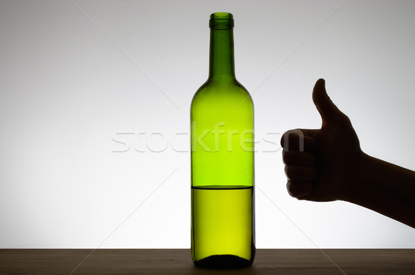 Thumbs up sign and a bottle of wine Stock photo © CsDeli