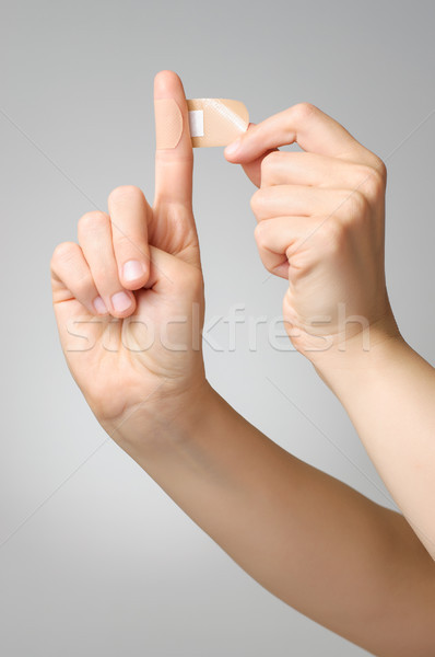 Woman with a plaster on her finger Stock photo © CsDeli
