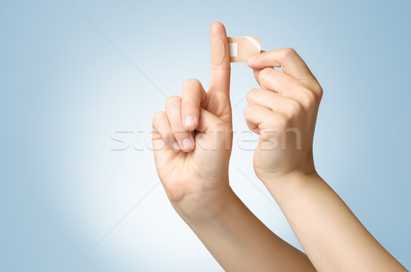 Woman with a plaster on her finger Stock photo © CsDeli