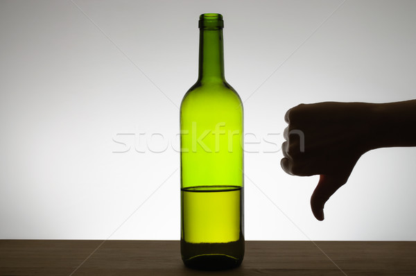 Thumbs down sign and a bottle of wine Stock photo © CsDeli