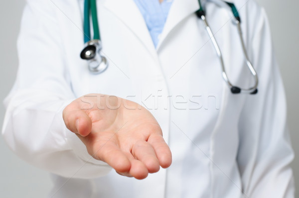 Female doctor showing her palm Stock photo © CsDeli