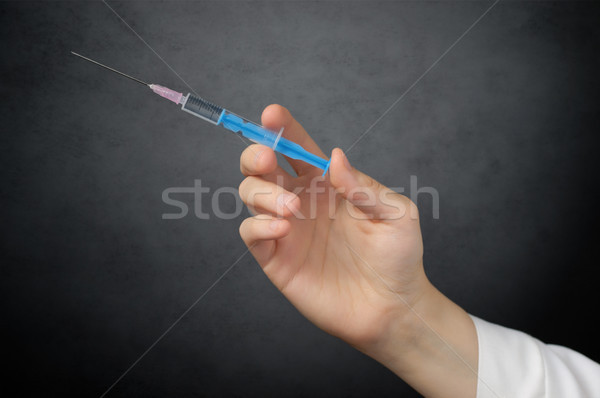 Doctor's hand with syringe Stock photo © CsDeli
