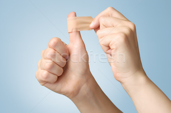 Woman with a plaster on her thumb Stock photo © CsDeli