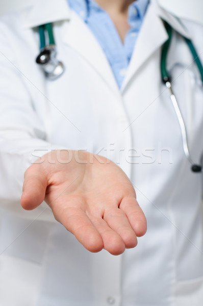 Female doctor showing her palm Stock photo © CsDeli