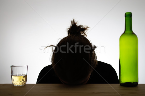 Silhouette of a drunk woman sleeping on a desk Stock photo © CsDeli