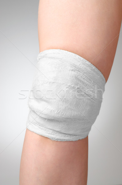 Stock photo: Injured knee with bandage