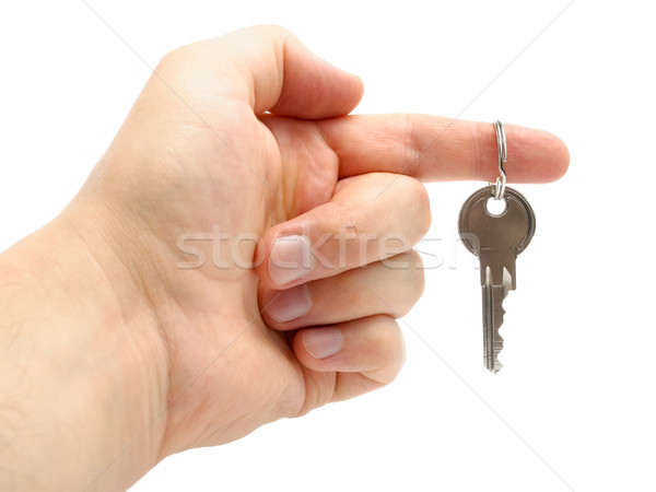 Hand holding a key isolated on white background Stock photo © CsDeli