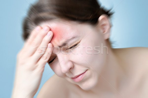 Young woman touching her head Stock photo © CsDeli