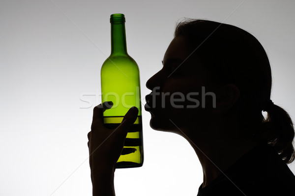 Alcoholic woman kissing a wine bottle Stock photo © CsDeli