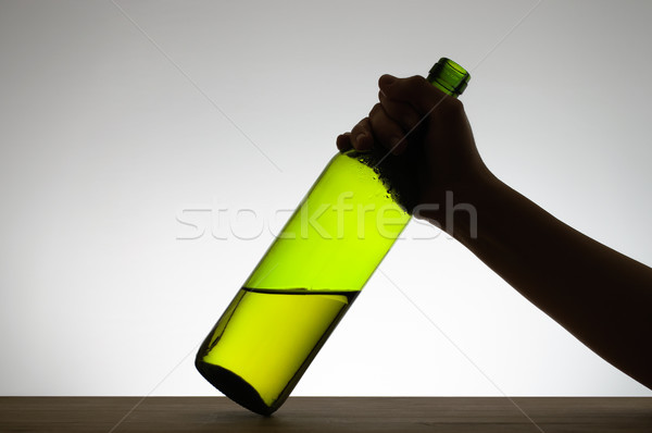 Female hand grabbing a bottle Stock photo © CsDeli