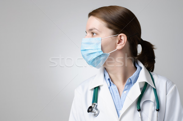 Arzt tragen medizinischen Maske weiblichen Gesicht Stock foto © CsDeli