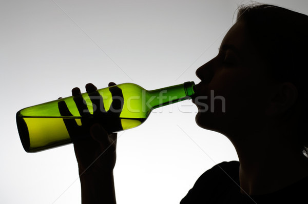 Alcoholic woman drinking from a bottle Stock photo © CsDeli