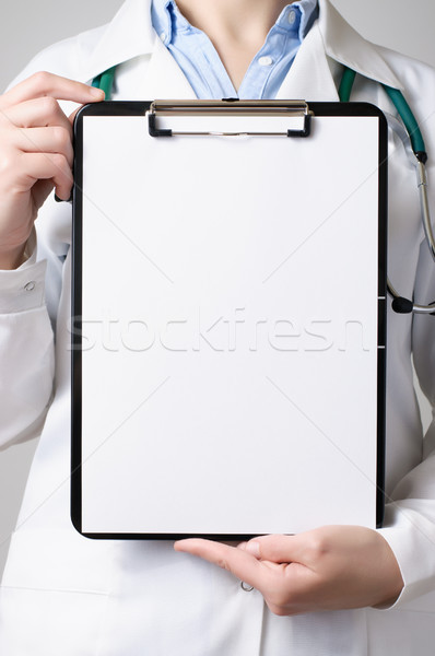 Doctor showing blank clipboard Stock photo © CsDeli