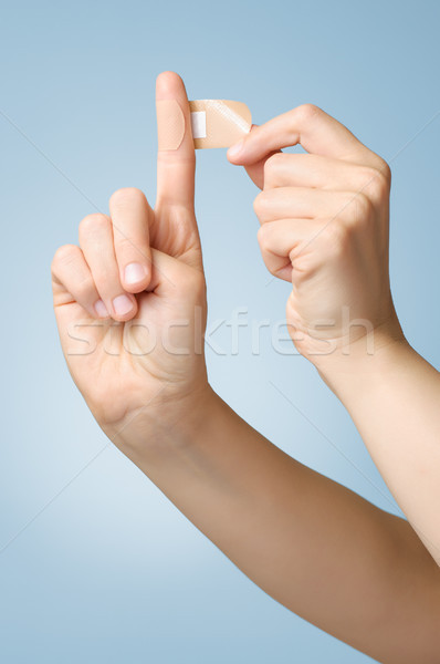 Woman with a plaster on her finger Stock photo © CsDeli